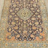 A Persian woollen rug, on a blue ground,