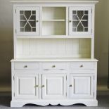 A white painted pine dresser, with a glazed upper section,