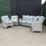 A grey rattan three seater sofa, 182cm, together with three armchairs,
