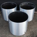 A set of three silver painted garden pots,