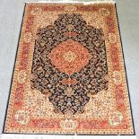 A Keshan style carpet, with a central medallion and foliate design, on a blue ground,