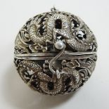 A Chinese white metal pierced censer, in the form of a hinged ball, 5cm diameter,