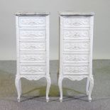 A pair of white painted bedside chests, with rouge marble tops, on cabriole legs,
