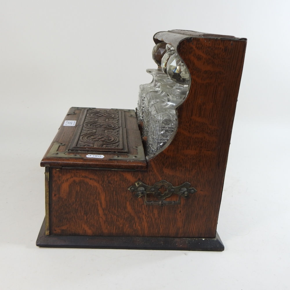 A 19th century carved oak and brass mounted tantalus, - Image 9 of 9
