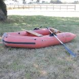 An inflatable dinghy, with a wooden base,