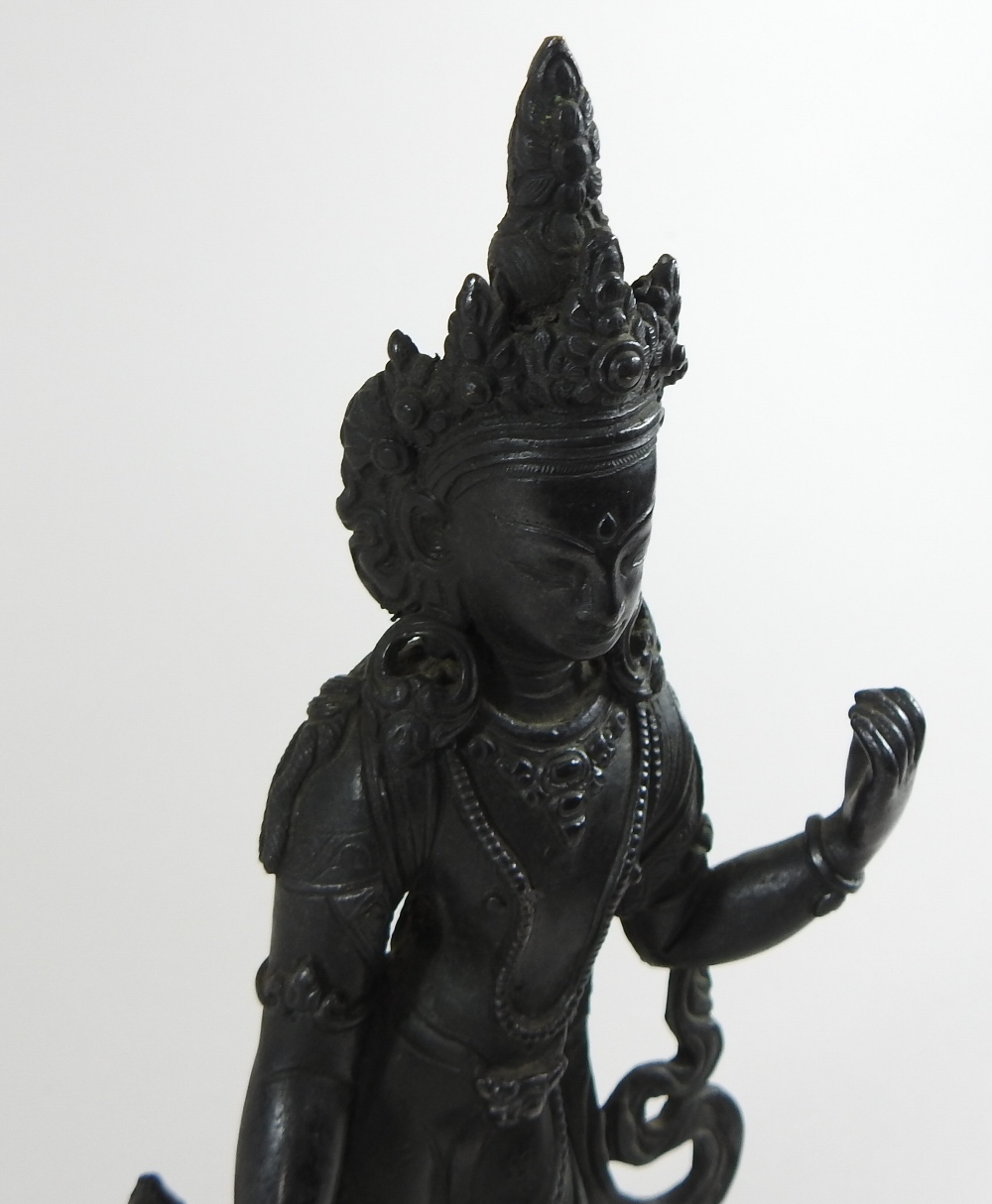 An Indian bronze figure of a deity, shown standing, on a circular base, - Image 2 of 4