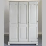 A cream painted triple wardrobe,