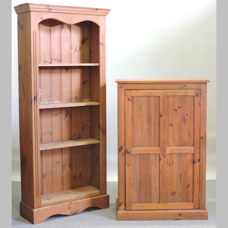 A pine standing open bookcase, together with a pine hall cupboard,