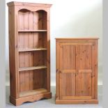 A pine standing open bookcase, together with a pine hall cupboard,