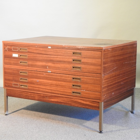 A 1970's teak plan chest, on metal legs,