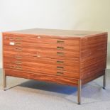 A 1970's teak plan chest, on metal legs,