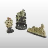 A Chinese soapstone carving of a rocky landscape, with buildings, trees and mountains, 22cm wide,