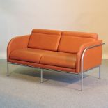 An Italian tan leather upholstered and tubular metal framed sofa, by Corinto,