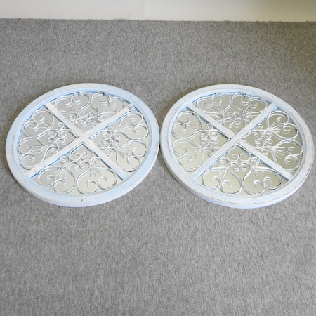 A pair of circular painted wall mirrors,