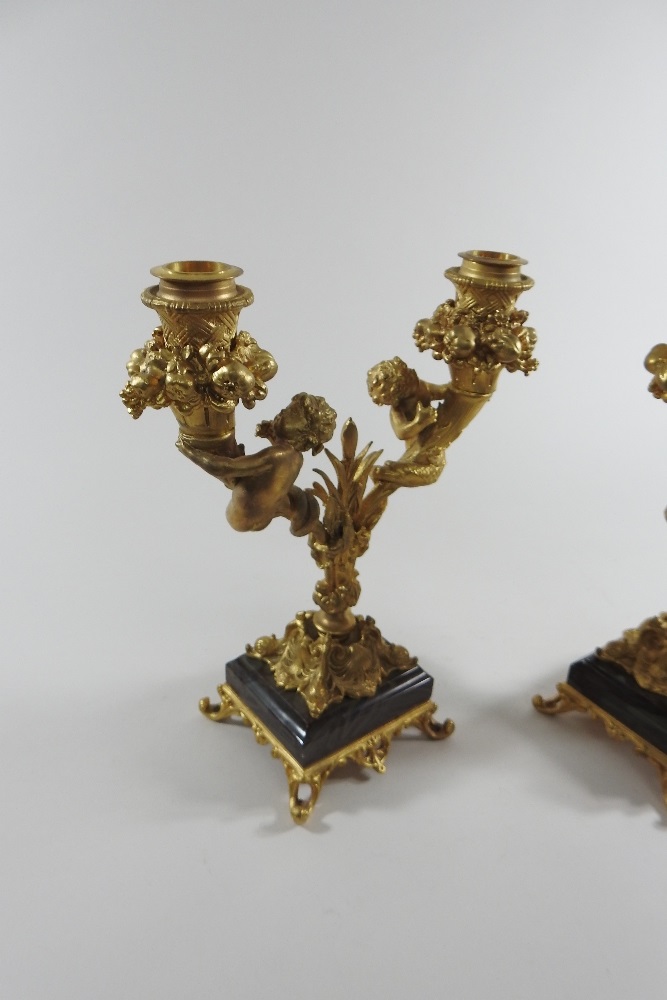 A pair of continental gilt bronze two branch table candelabra, decorated with fruit and putti, - Image 6 of 8