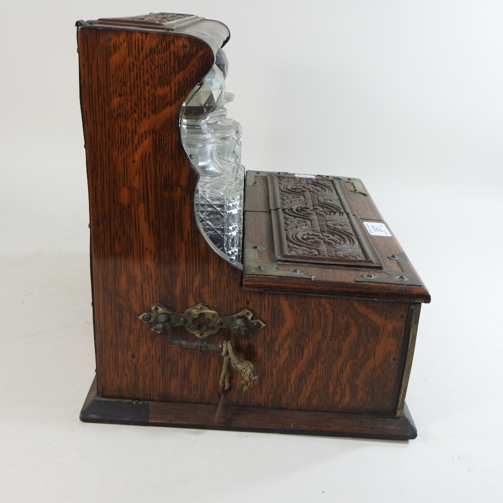 A 19th century carved oak and brass mounted tantalus, - Image 8 of 9