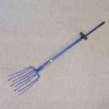 Two blue painted manure forks