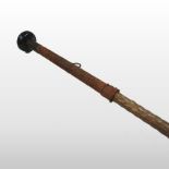A 19th century basque makhila wooden walking stick, with a concealed spike and braided handle,