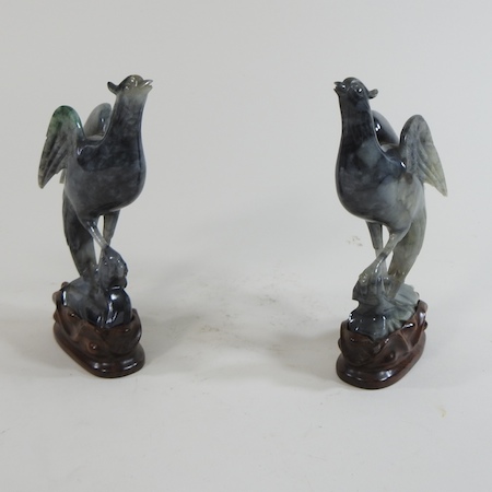 A pair of jade coloured carvings of birds,