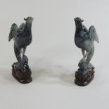 A pair of jade coloured carvings of birds,