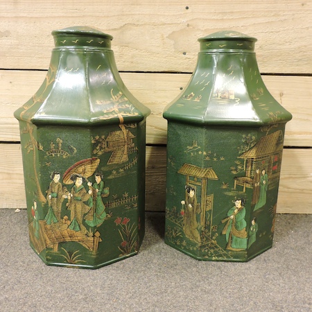 A pair of reproduction green painted metal octagonal tea canisters,