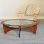 An Ercol light elm stick back open armchair, with loose cushions,