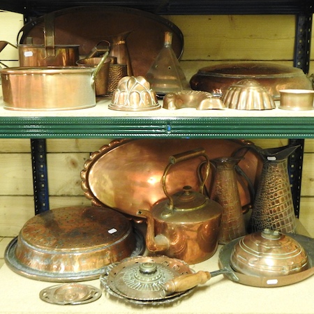 Two shelves of copper items, to include a funnel, sieves, jelly moulds,