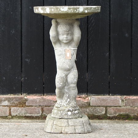 A reconstituted stone bird bath,