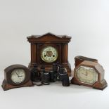 An Edwardian walnut mantel clock, together with two others,