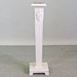 A white painted pedestal, with a marble top,