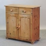 A pine side cabinet, with short drawers and cupboards,