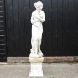 A reconstituted stone figure of Venus, on a pedestal,