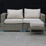 A beige rattan two seater garden sofa, with cushions, 170cm,