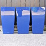A set of three blue garden pots,