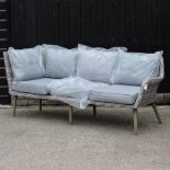 A grey rattan garden sofa, with cushions,