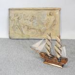 A Roman style fibreglass relief panel, 52 x 83cm, together with a reproduction model ship,