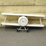 A novelty wall clock, in the form of an aeroplane,