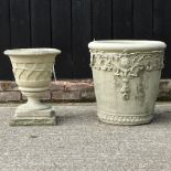 A circular stone planter, 47cm, together with a reconstituted stone urn,