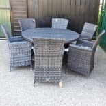 A circular rattan garden table, 140cm,