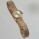 A mid 20th century 9 carat gold cased Longines ladies wristwatch, on a flexible 9 carat gold strap,