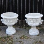 A pair of reconstituted stone planters,