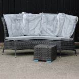 A curved rattan garden bench, with cushions, 175cm,