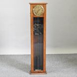 An early 20th century light oak cased synchronome electric wall clock, with a glazed case,