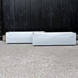 A pair of silver coloured garden troughs,