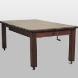 An early 20th century mahogany wind out extending dining table,