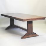 A mid 20th century hardwood refectory dining table, in the manner of Heals, on a trestle base,