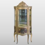 A French gilt and Vernis Martin style bow front display cabinet, fitted with glass shelves,