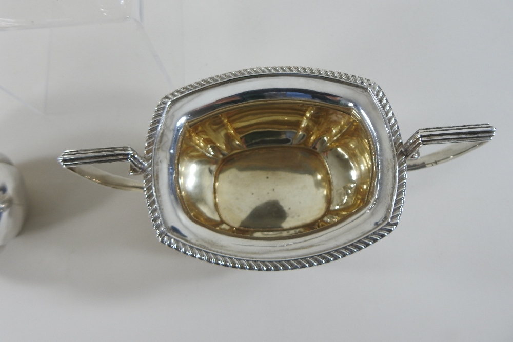 An early 20th century silver three-piece tea service, comprising a teapot, sugar bowl and cream jug, - Image 7 of 12