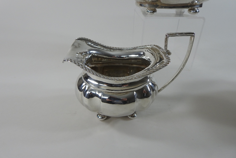 An early 20th century silver three-piece tea service, comprising a teapot, sugar bowl and cream jug, - Image 10 of 12