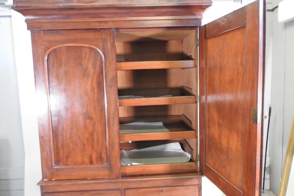 A 19th century mahogany linen press, fitted with slides, standing on a plinth base, - Image 12 of 12